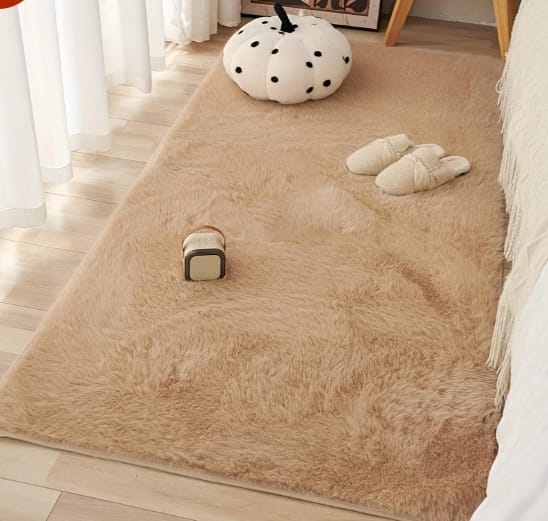 Soft beige shaggy rug beside a bed
